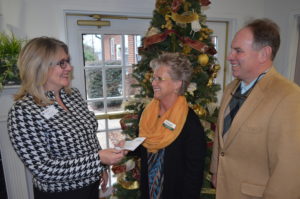 Kelley Ezell, executive director of the Upstate Family Resource Center, left, receives a $3,000 check from representatives from Entegra Bank